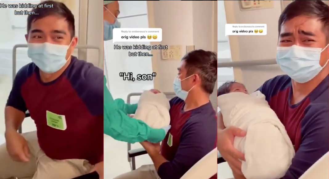 father crying when taking new born baby boy 1